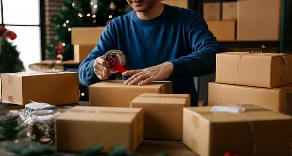 Someone preparing package during peak shipping season